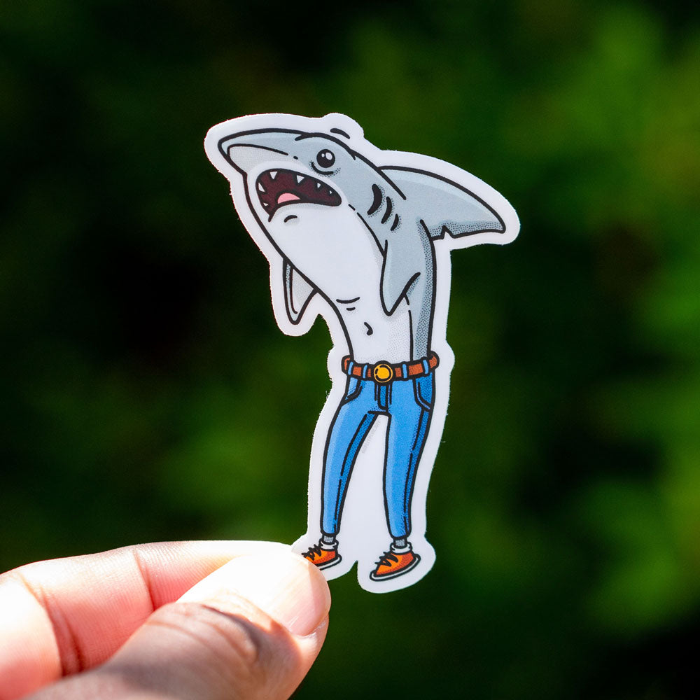 A sticker of a shark who is shocked that they are wearing skinny jeans
